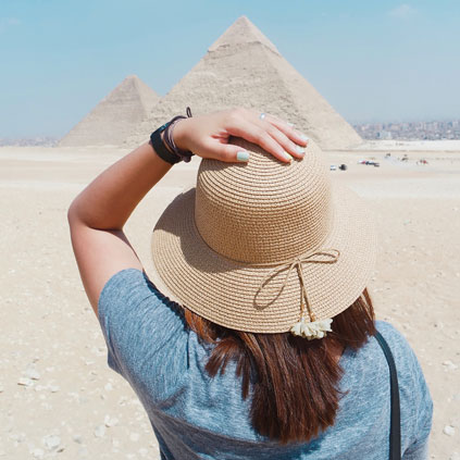 Frau blickt im Kairo Urlaub auf die Pyramiden von Gizeh